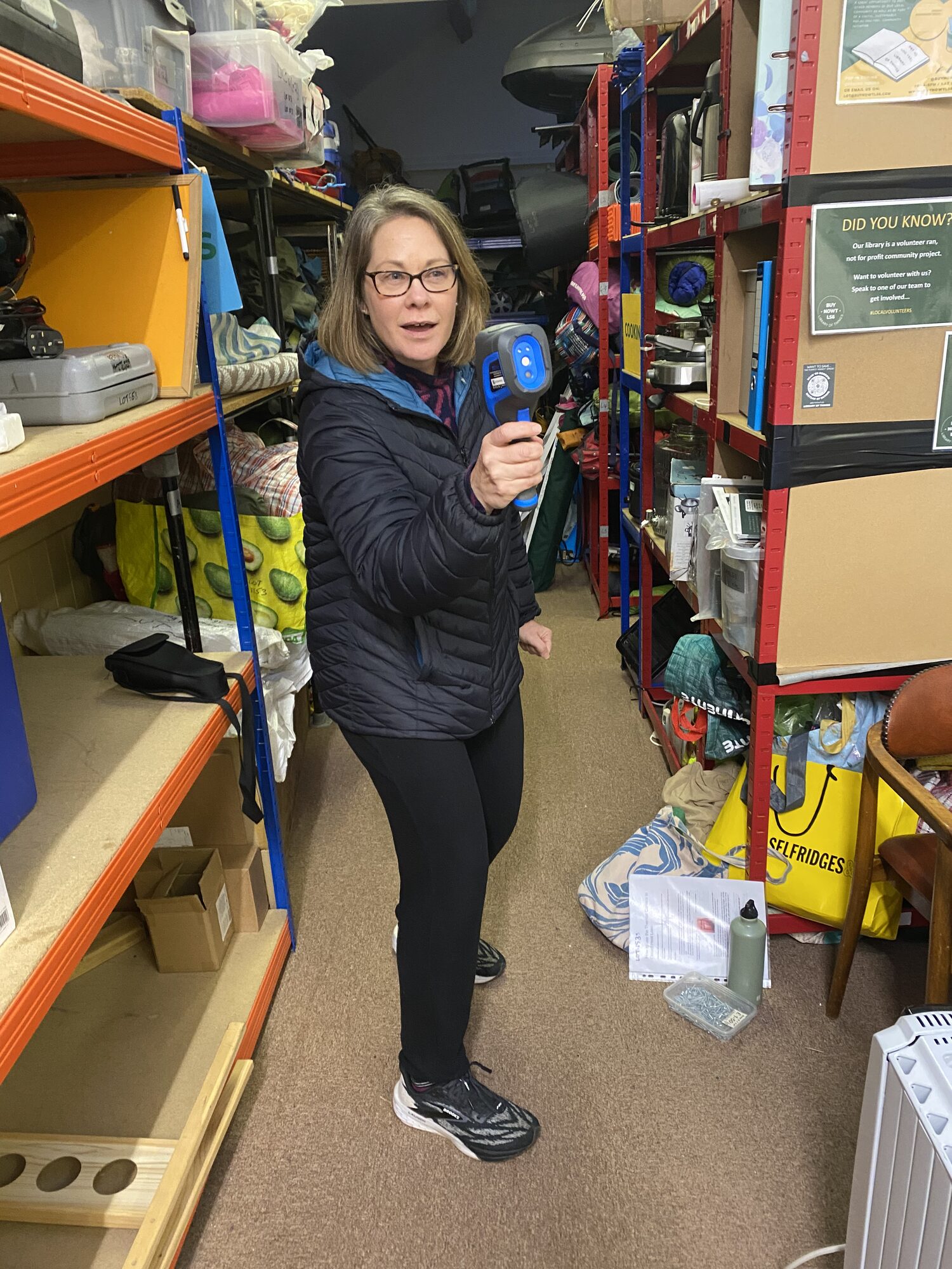 A volunteer using the thermal imaging camera from the Cosy Homes Project